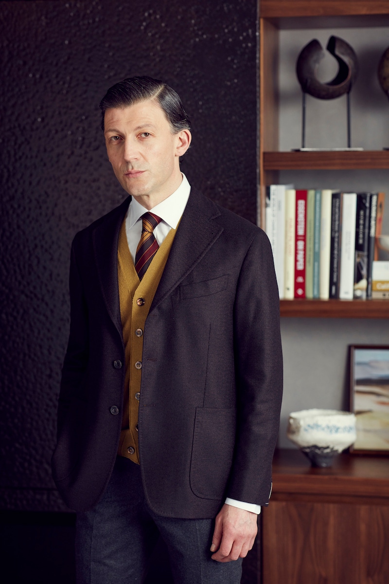 Chocolate brown herringbone single breasted jacket,Rubinacci; White cotton oxford shirt, Gieves and Hawkes; Brown silk and cotton multi stripe tie, Drakes; Mustard cashmere vest, Rubinacci; Charcoal flannel wool flat front trouser, Gieves and Hawkes.