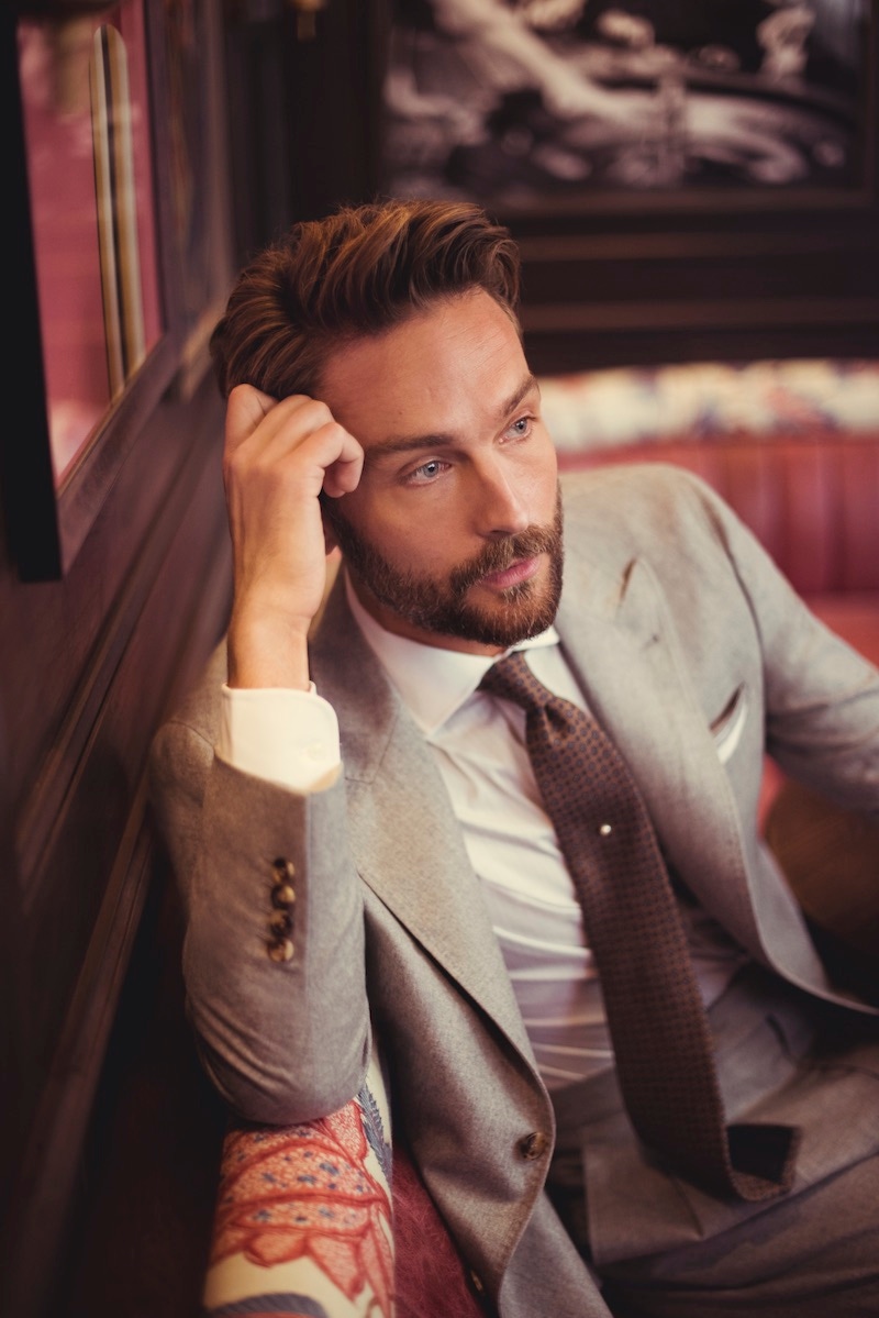 Grey flannel suit, Brunello Cucinelli; multi-striped cotton contrast collar and double cuff shirt, Hackett; brown and light blue patterned cashmere tie, Emma Willis.