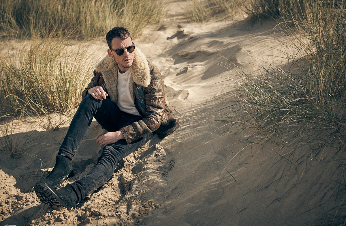 Shearling bomber jacket, Polo Ralph Lauren; ecru cashmere ribbed crewneck, Private White V.C; black suede slip-on boots, Grenson; sunglasses Cutler & Gross.