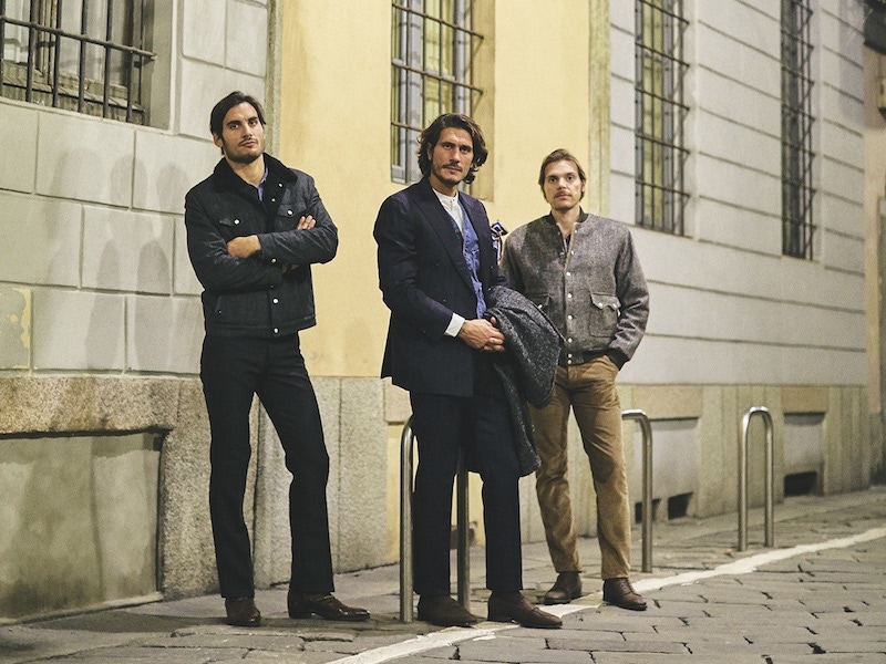 Left to right: Japanese cotton-linen pinstriped Bud shearling trucker jacket; indigo blue Giuliano Oxford shirt; Stendhal snakeskin printed leather boots; trousers, his own. Blue washed denim Jesse vest; white Giuliano jacquard cotton Oxford shirt: dark brown kudu waxy leather Guttuso loafers. Suit, his own. Muddy VBC x Barbanera wool shearling bomber; light brown corduroy Bronson trousers.