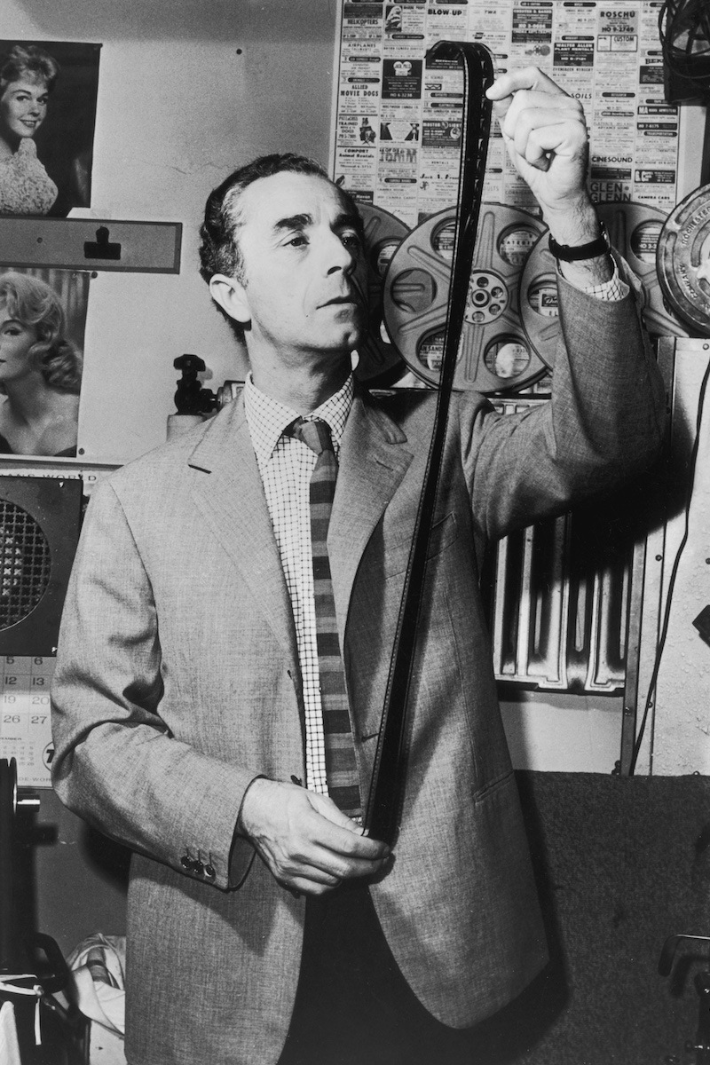 Michelangelo Antonioni looks at a strip of film in a film lab. (Photo by Hulton Archive/Getty Images)