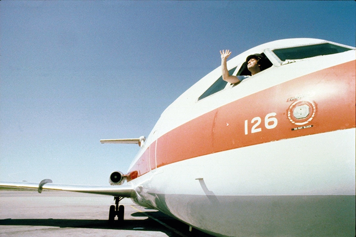 Waving from the window of a plane while on tour in the Midwest in 1980 (Photo by Richard E. Aaron/Redferns)