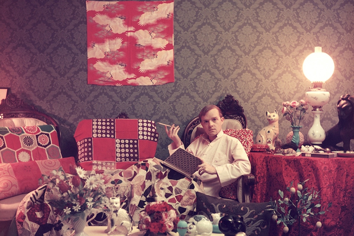 Author Truman Capote (1924 - 1984) relaxes with a book and a cigarette in his cluttered apartment, Brooklyn Heights, New York. Original Publication: A Wonderful Time - Slim Aarons   (Photo by Slim Aarons/Getty Images)