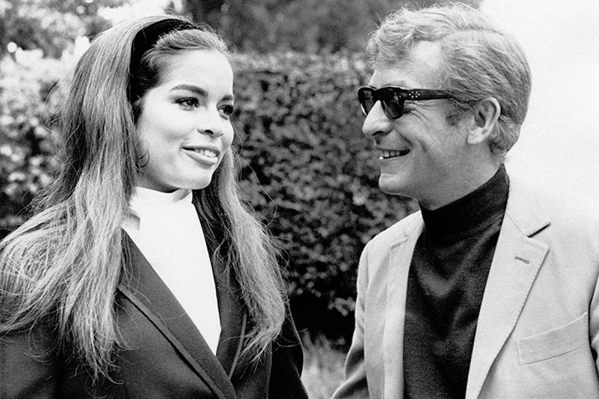 British actor Michael Caine, smiling, walking in a park with her girlfriend, Nicaraguan model Bianca De Macias. Turin (Italy), August 1968. (Photo courtesy of Getty)