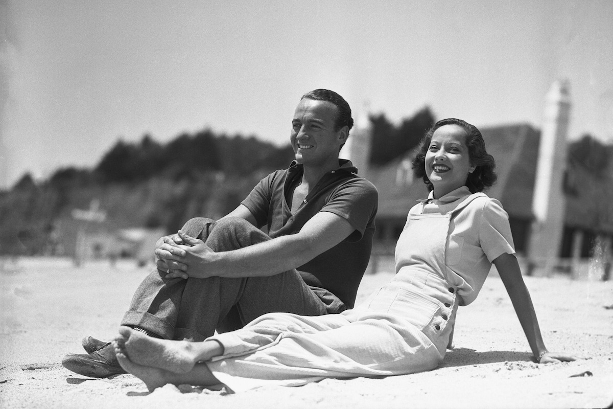 Merle Oberon, British screen favorite, is pictured above with David Niven, ex-lieutenant in the Scottish Highland Infantry, and son of the late Lady Comyn-Platt, at Santa Monica Beach, California. (Photo courtesy of Getty)