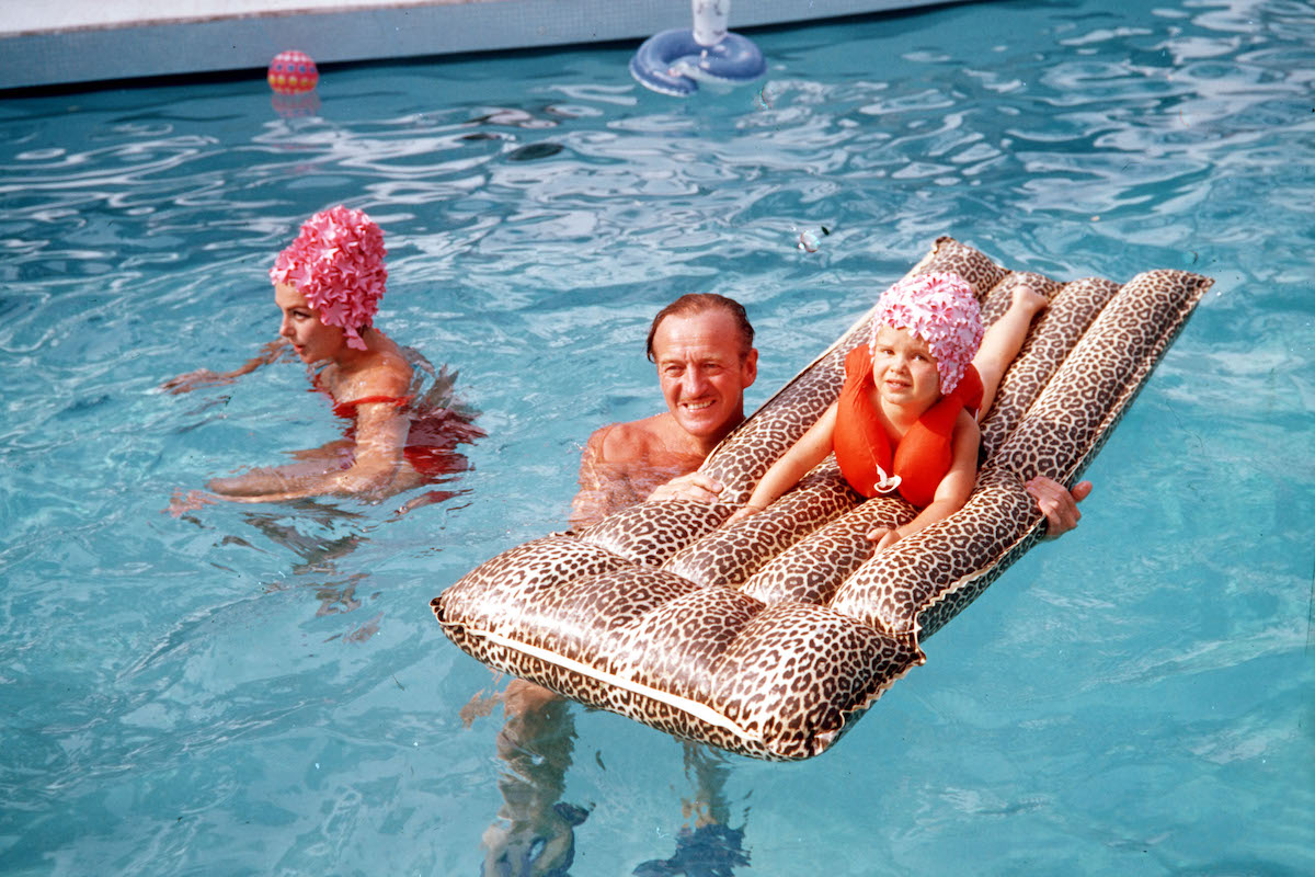 David Niven is pictured with his wife Hjordis Genberg and daughter in the swimming pool at their home  (Photo by Popperfoto via Getty Images/Getty Images)