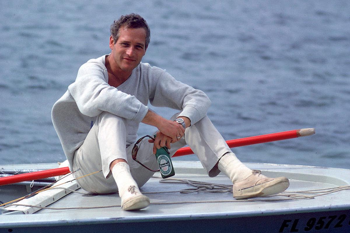 Paul Newman sitting on prow of boat, holding Heineken beer (Photo by Mark Kauffman/Time & Life Pictures/Getty Images)