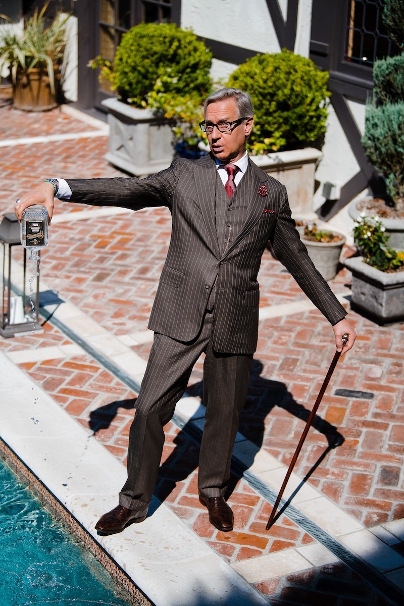 Bespoke brown pinstripe three-piece suit, Anderson & Sheppard; white bespoke shirt, Anto of Beverly Hills; red special edition for Neiman Marcus tie, Turnbull & Asser; boutonnière, Charvet; pocket-square, Lanvin; eyewear, Prada; brown Churchill, G.J. Cleverley; yellow- and white-gold chain attached to vintage pocket watch, Omega.