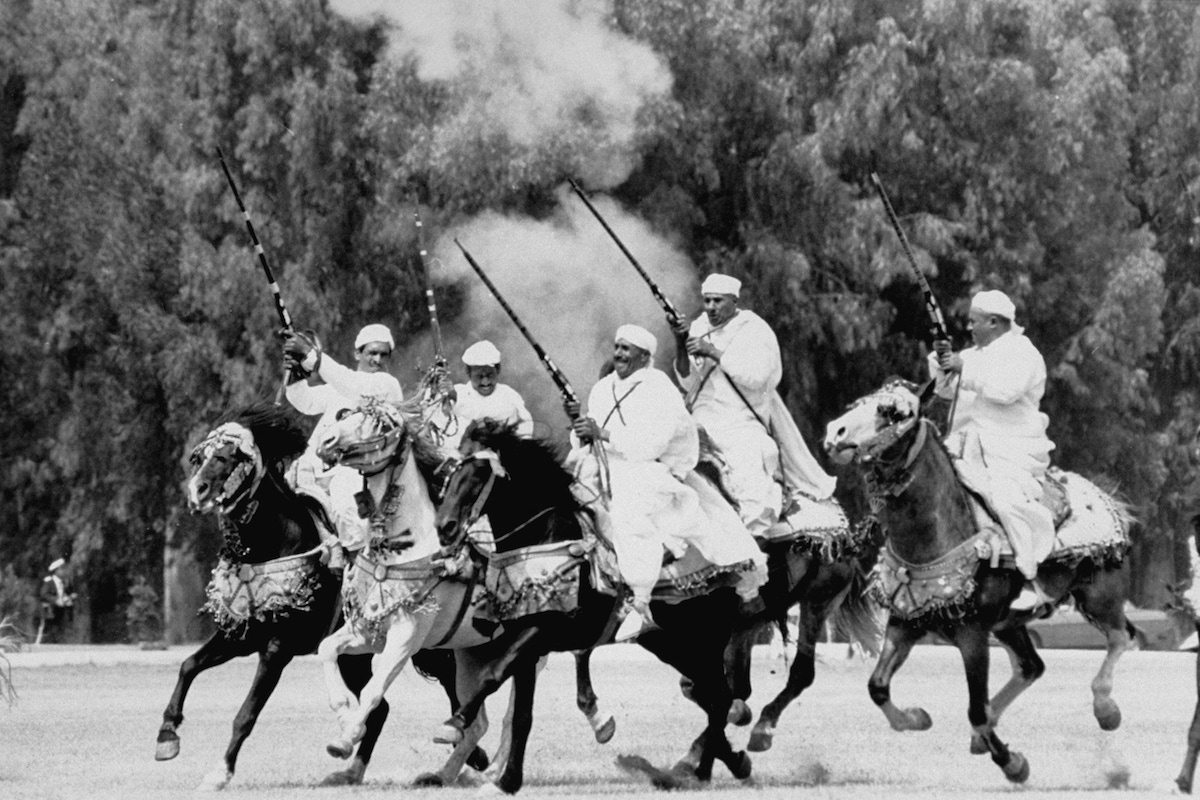 Moroccan horsemen display their decorative riding & shooting at Malcolm Forbes' 70th birthday gala on grounds of his Tangier Country Club.  (Photo by Terry Smith/The LIFE Images Collection/Getty Images)