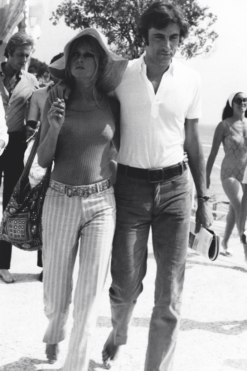 The French actress and model Brigitte Bardot walking with the Italian actor and playboy Gigi Rizzi. Saint-Tropez, August 1968 (Photo by Mondadori Portfolio via Getty Images)