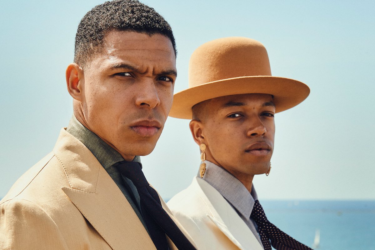 Kidane (left): Caramel linen suit jacket, De Petrillo at The Rake; forest green linen shirt, 100 Hands at The Rake; brown damask Madder silk tie, Budd Shirtmakers. Solomon (right): Cream Fox Flannel double- breasted jacket, Edward Sexton at The Rake; grey brushed cotton shirt and wine and fawn polkadot wool tie, Budd Shirtmakers. Hat and earrings, Solomon’s own.