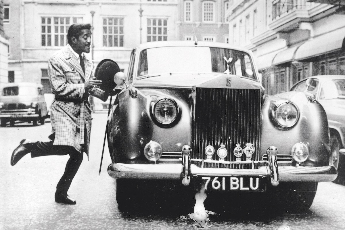 Sammy Davis Jr. skips to his Rolls-Royce in Liverpool, 1963 (Photo by Keystone/Getty Images)