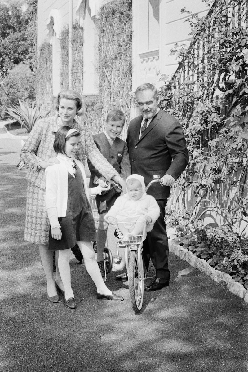 Posing in the garden of their palace, Prince Rainier and Princess Grace of Monaco, who will mark their 10th wedding anniversary April 18th, are shown with their children: Princess Stephanie, 14 months; Princess Caroline, 9; and Prince Albert, 8. (Image by © Bettmann/CORBIS)