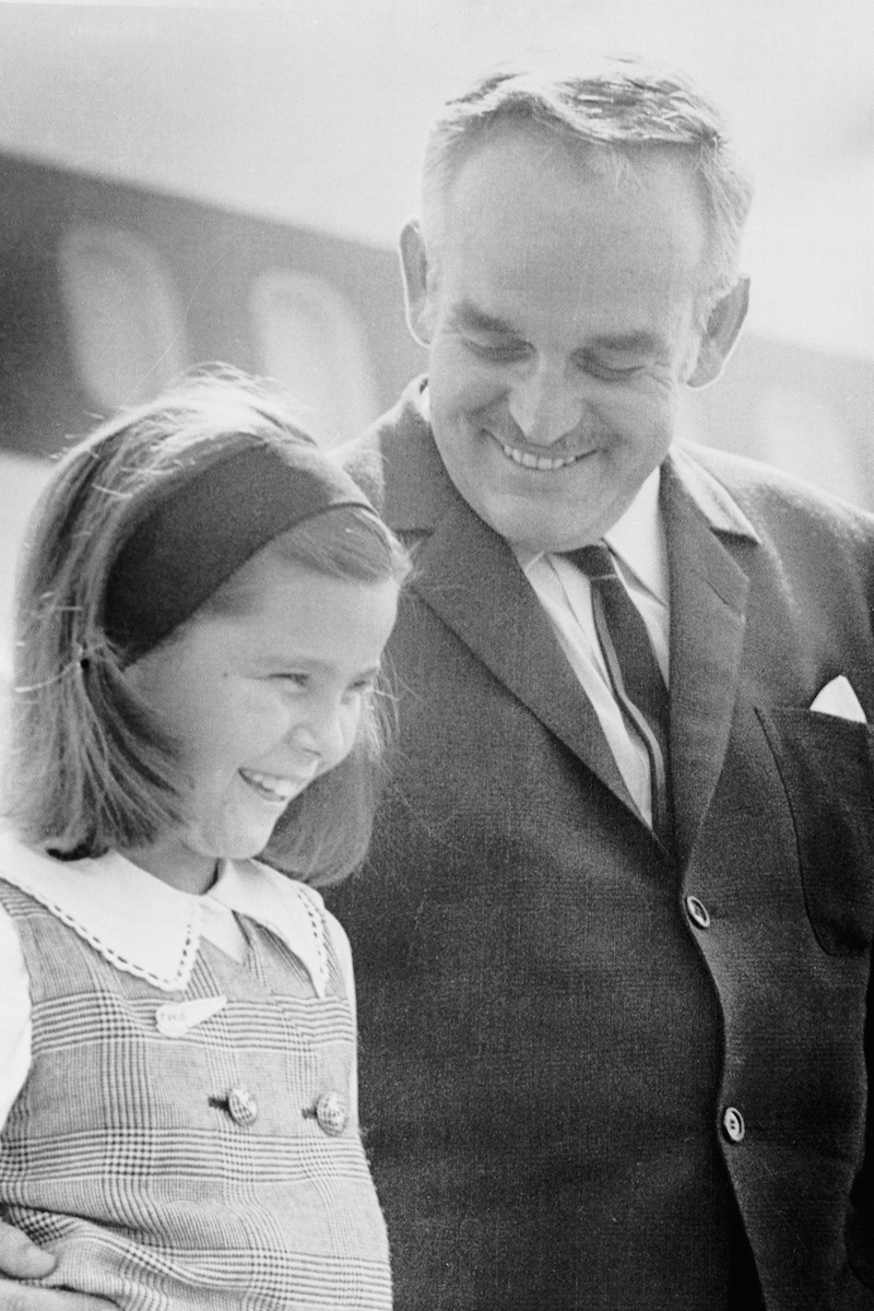 Prince Rainier III of Monaco and his daughter, Caroline, 9, flash two royal smiles at Logan Airport  (Image by © Bettmann/CORBIS)