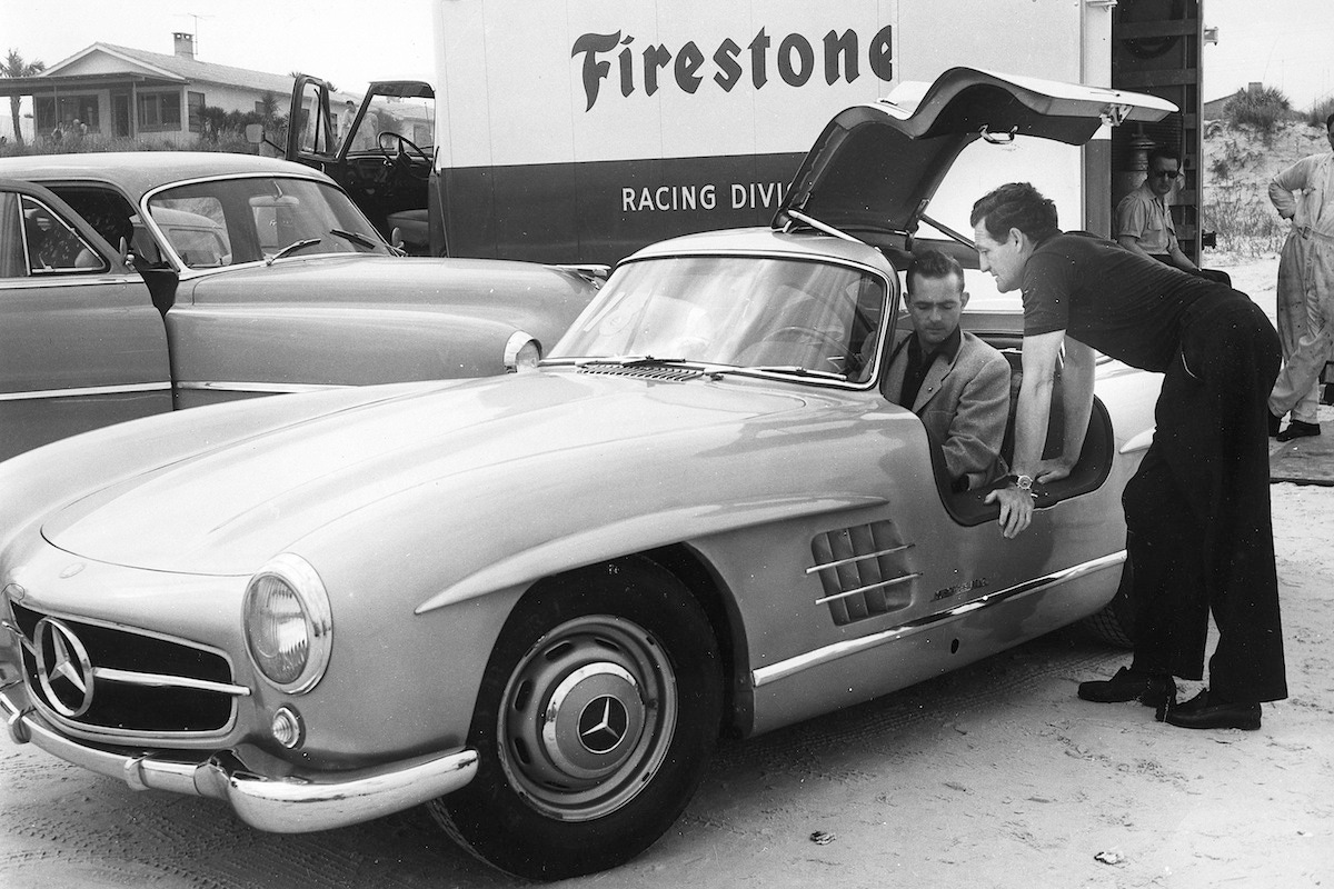 Racing drivers Phil Hill and Briggs Cunningham check out a new 