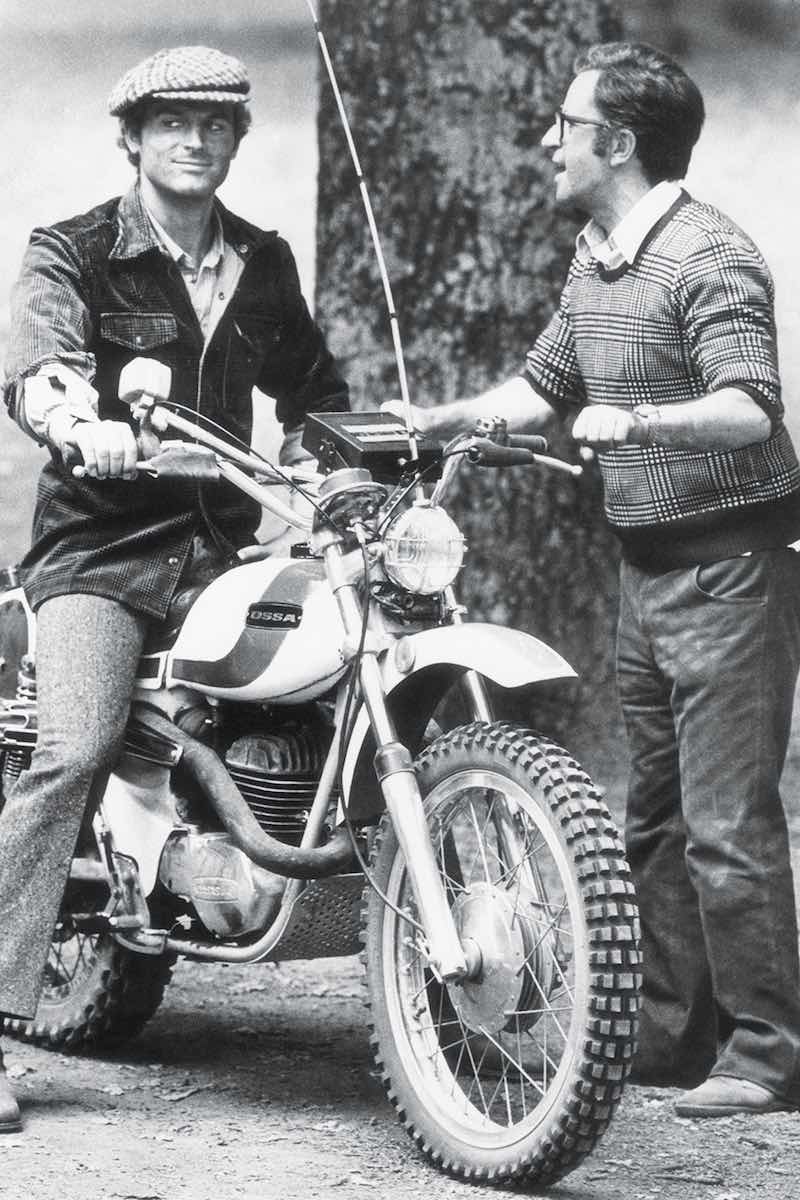 The late Italian director Marcello Fondato showing Hill how to drive an Ossa motorbike on the set of Watch Out, We’re Mad! in Rome in 1974 (Photo by Rino PetrosinoMondadori via Getty Images)