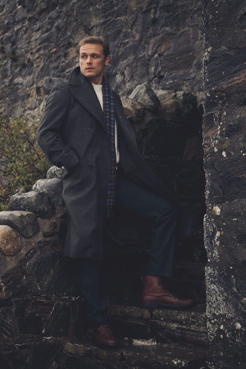 Pure wool ‘Naphill’ greatcoat, Kit Blake at The Rake; cream cashmere ribbed crewneck sweater, Connolly; cashmere scarf, Joshua Ellis; mottled olive green House trousers, Edward Sexton at The Rake; Damson Utah ‘Galway’ boots, Edward Green at The Rake.