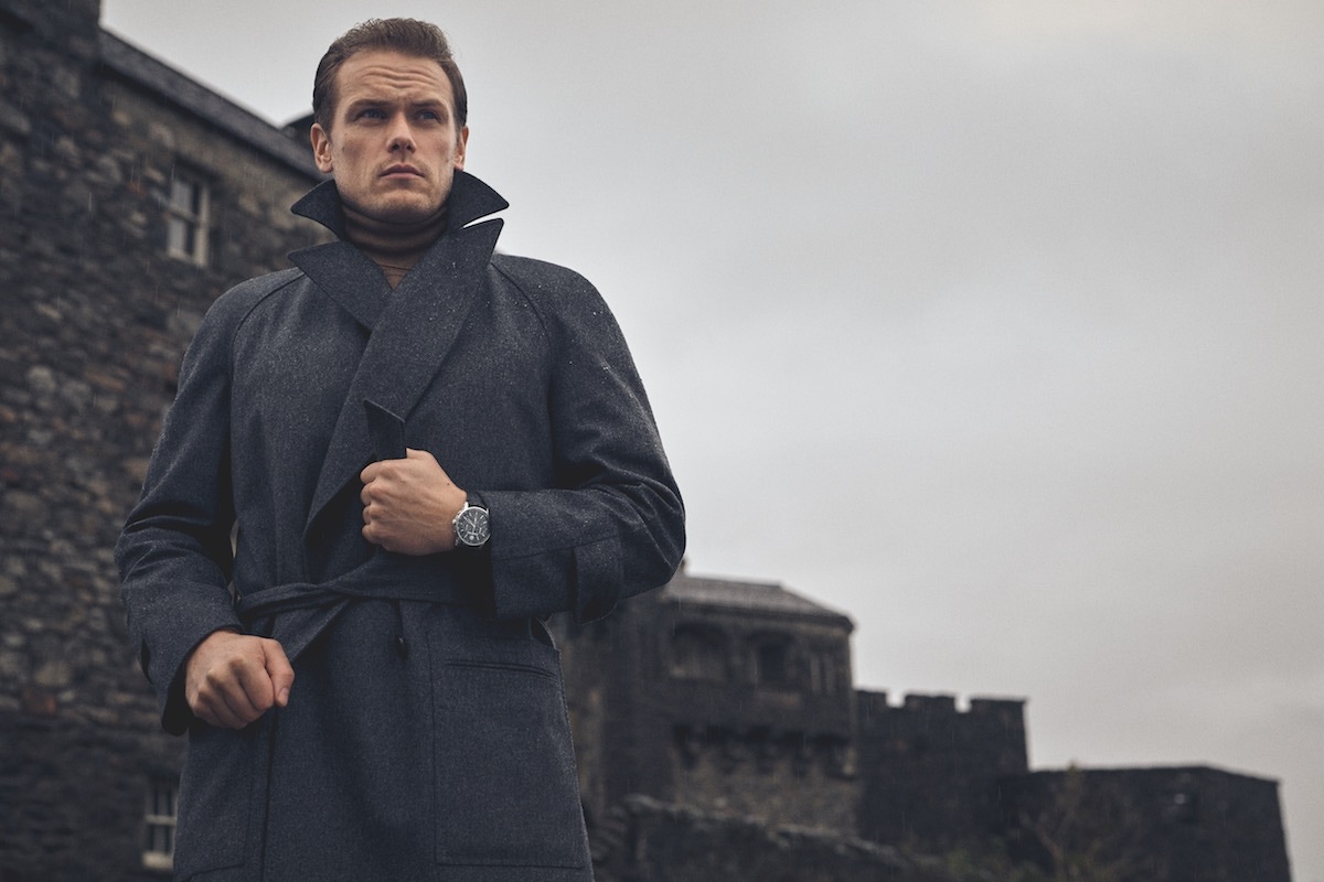 Storm-proof grey flannel raglan coat, Edward Sexton at The Rake; cashmere wool roll-neck, New & Lingwood; Code 11.59 by Audemars Piguet Selfwinding Chronograph,18-carat white-gold case, lacquered black dial and counters. Black alligator strap with white-gold buckle.