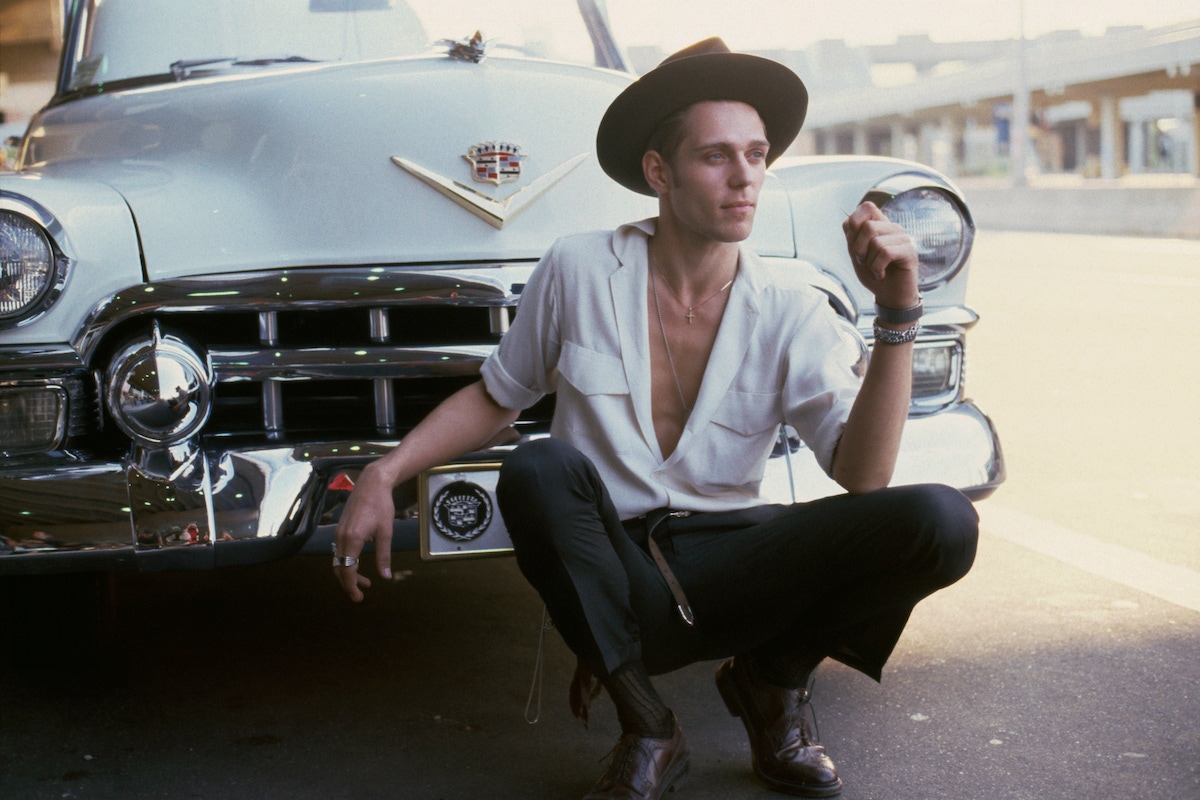 Paul Simonon of The Clash in front of a car at JFK Stadium in Philadelphia, PA. September 25, 1982.  (Photo by Bob Gruen)