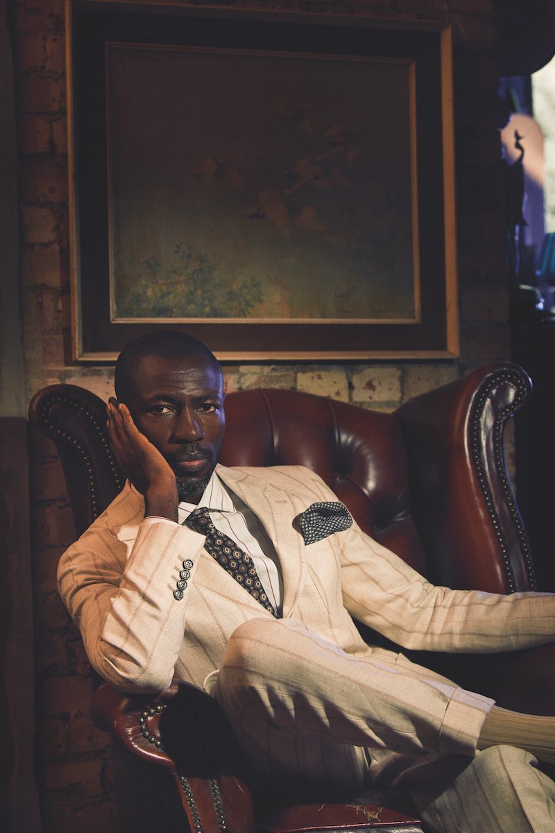 Cream linen, wool and silk chalkstripe suit, Brunello Cucinelli; white cotton striped shirt and brown silk printed tie, both Lardini; grey cashmere pocket-square, Anderson & Sheppard; beige cotton socks, London Sock Company.