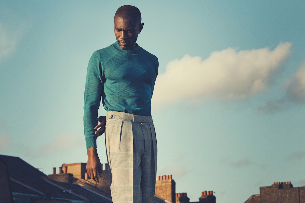 Teal Frankland quarter-neck jersey, Yuri & Yuri at The Rake; grey wool blake check Aleks pleated trousers, Kit Blake at The Rake; black leather Chelsea boots, Crockett & Jones.