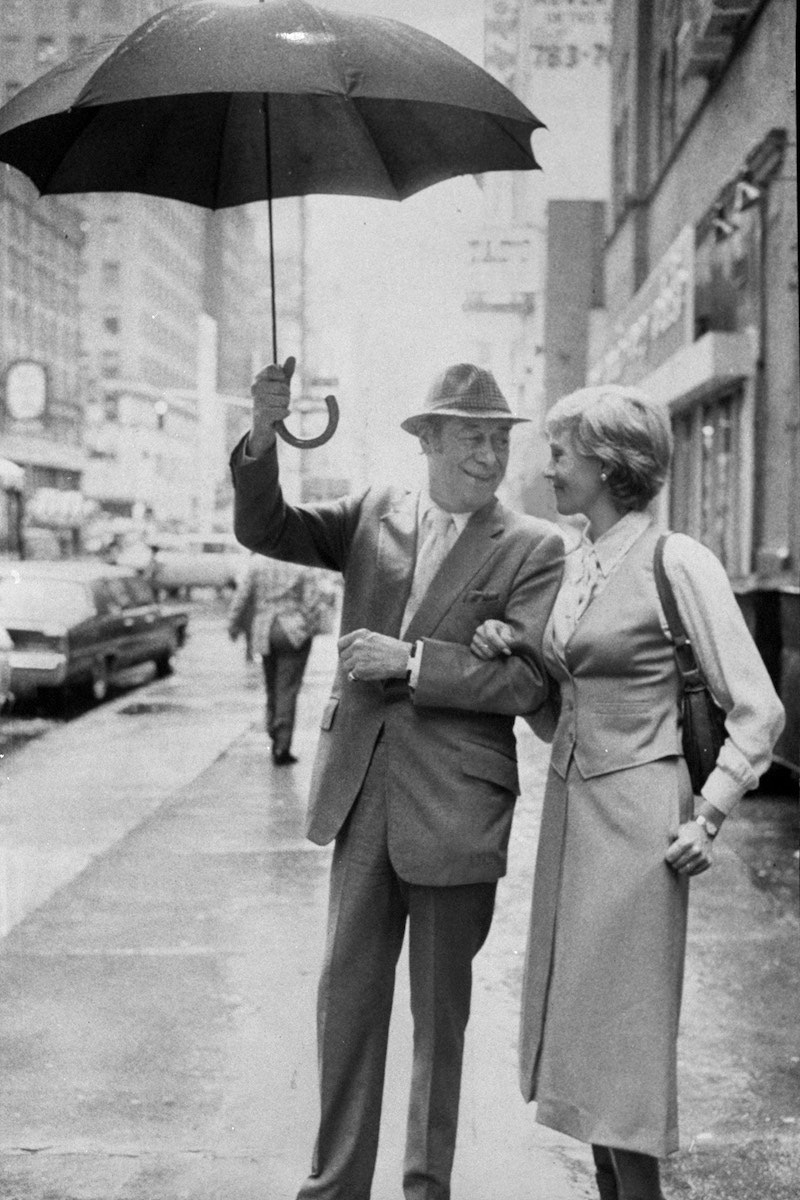 Rex Harrison holds an umbrella for Julie Andrews in 1979 (Photo by Richard Corkery/NY Daily News Archive via Getty Images)