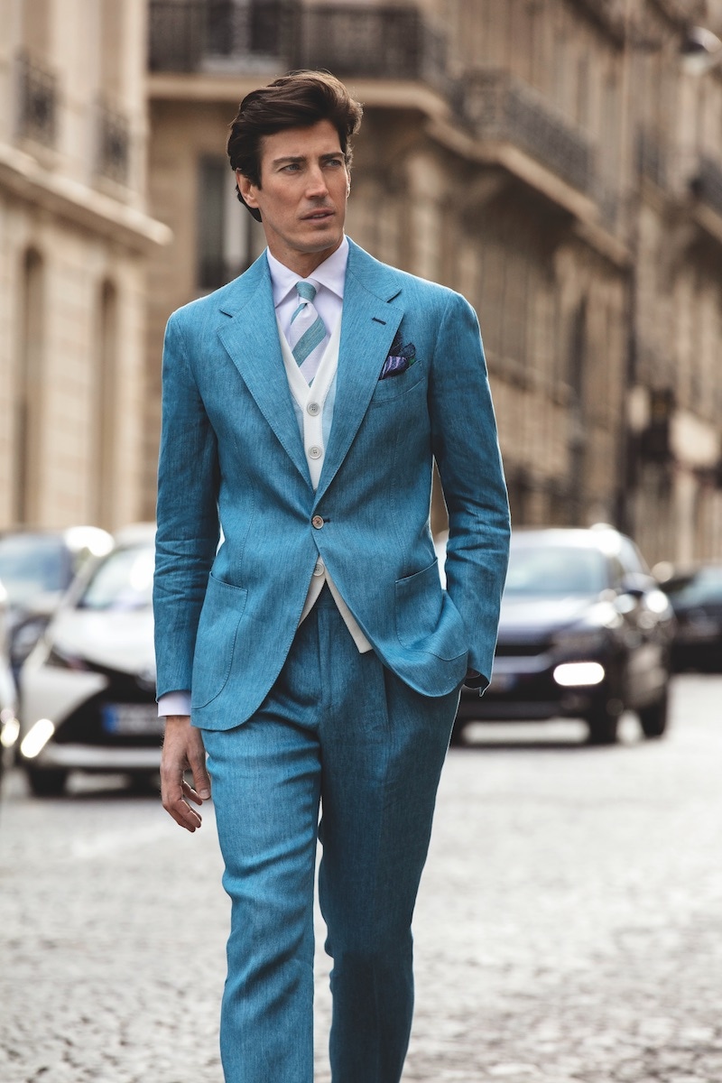 Riviera: Light blue sport jacket; light blue sport trousers; white sport shirt with one-piece collar; light blue knitted cotton waistcoat; turquoise and white club silk tie; blue and purple floral pocket-square; beige suede loafers.