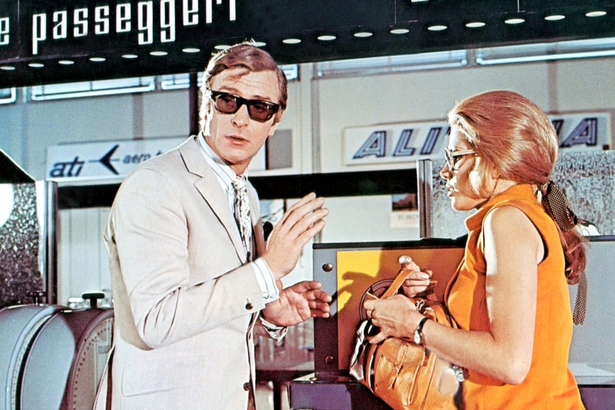 Michael Caine sporting a pair of Curry & Paxton sunglasses, opposite Maggie Blye in The Italian Job (1969) (Photo by Everett Collection / Rex Features (682788r)