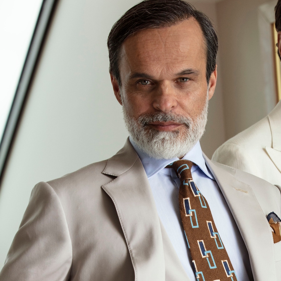 Iconic II: Three-piece beige wool suit; light blue classic shirt; brown silk tie with blue and white rectangles; khaki floral pocket-square.