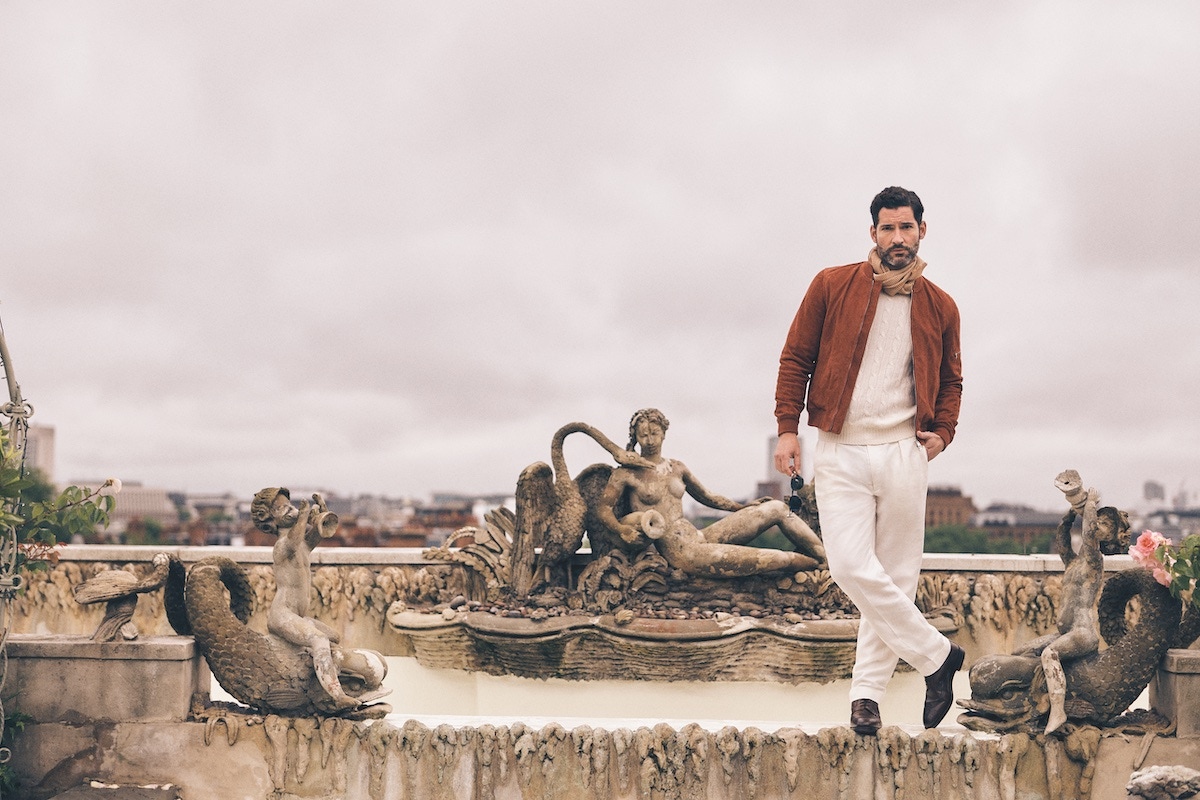 Burnt orange bomber jacket, Valstar; white cashmere jumper and white line trousers, both Ralph Lauren; beige and white linen polkadot scarf, Anderson & Sheppard; brown calf leather boots, George Cleverley at The Rake; brown tortoise sunglasses, Cutler & Gross