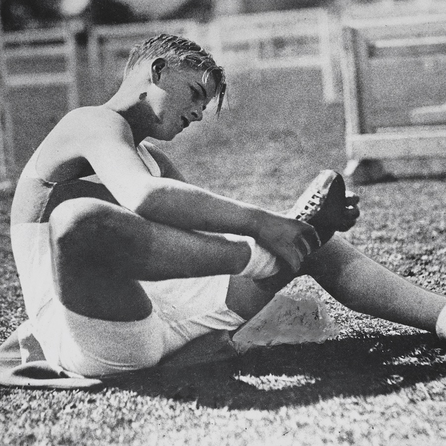 Philip checking his studs before a race while at Gordonstoun (Photo by Paul Popper/Popperfoto/Getty Images)