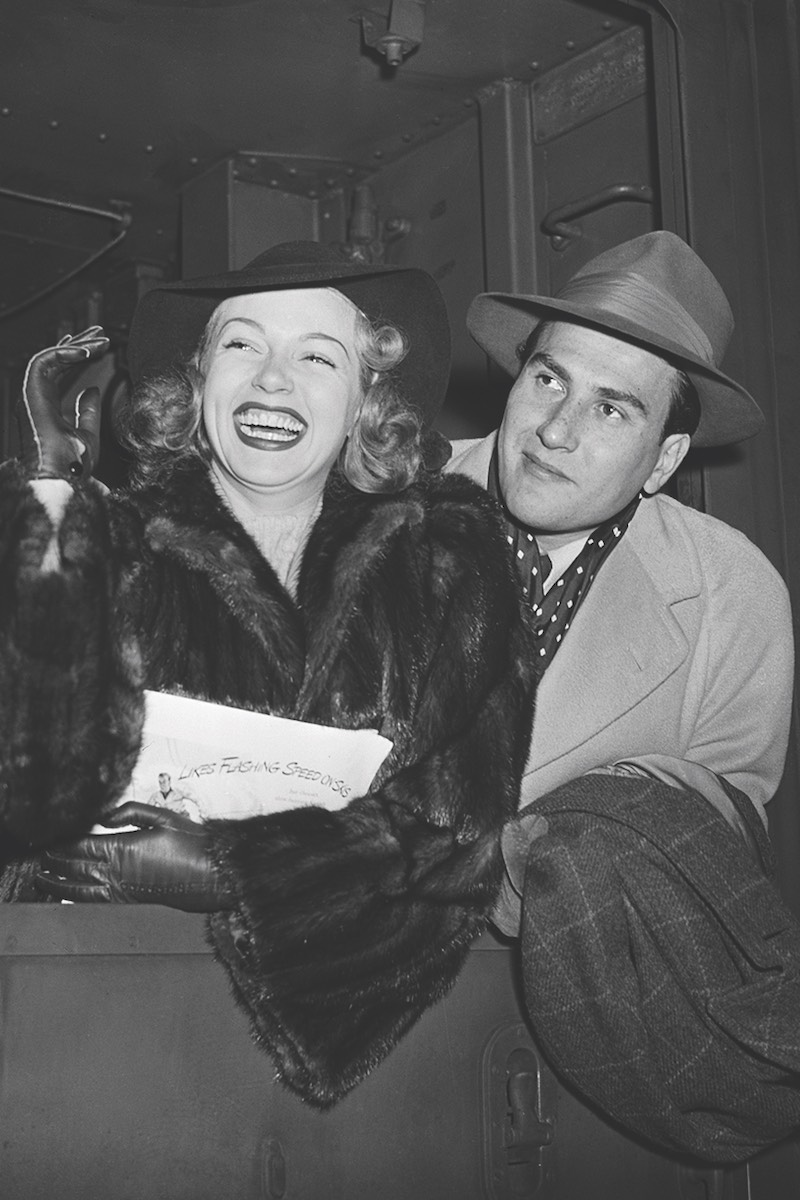 With Lana Turner, arriving in New York by train in 1940 (Photo via Getty)