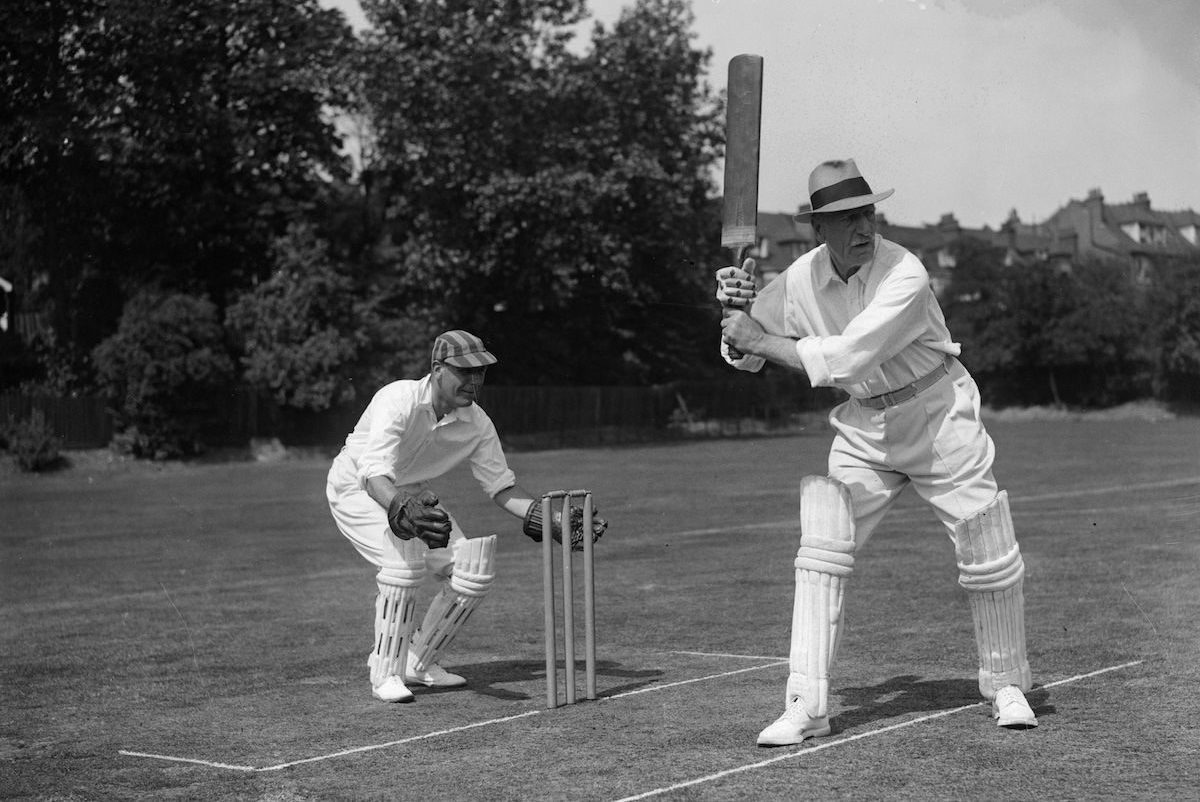 Captain of the actors' team C. Aubrey Smith batting and captain of the musicians' team B Walton O'Donnell keeping the wicket at the annual actors vs musicians match in aid of the Musicians Benevolent fund, at Hampstead Cricket Club, London, 1935. Photo by H. Allen/Topical Press Agency/Getty Images.