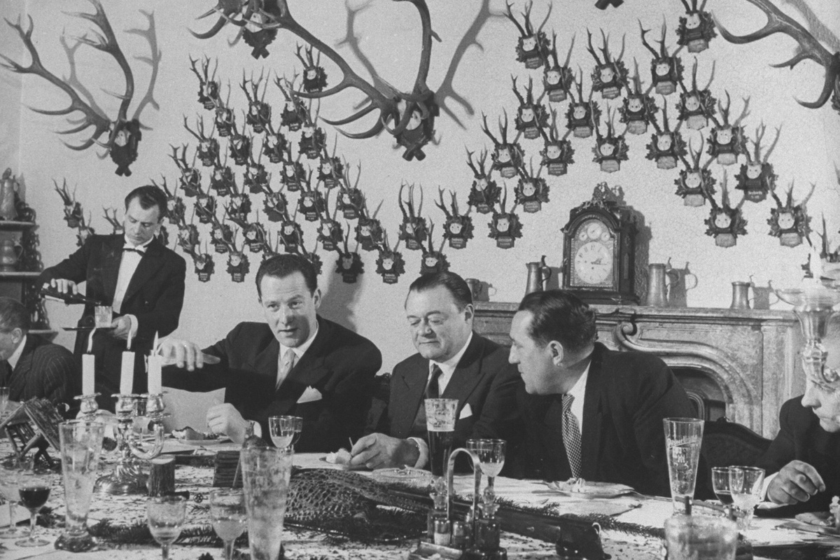 Czech premier Antonin Gottwald (R) attending a dinner party after a pheasant shoot. (Photo by Loomis Dean/The LIFE Picture Collection/Getty Images)