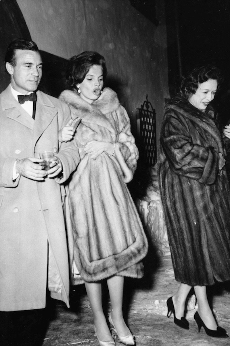 Diplomat and racing driver Porfirio Rubirosa and his wife Odile Rodin (centre) leaving the night club 'Chesa Veglia' in Saint Moritz in Switzerland, circa 1960. (Photo by Keystone/Hulton Archive/Getty Images)