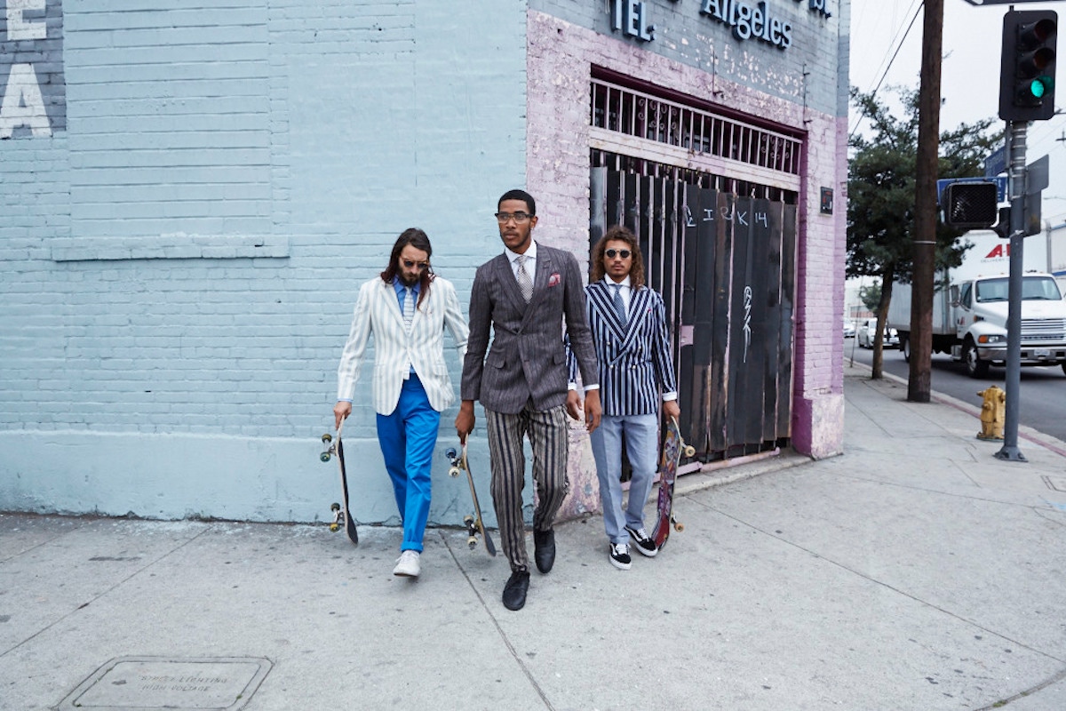 From left: Sky blue and ecru striped wool-flannel blazer, Hackett; blue cotton trousers, Richard James; sky blue linen shirt, Emma Willis, Grey-blue knitted silk tie, Hackett. White canvas trainers, Vans, property of the skater.  Charcoal silk-linen-wool fine-striped sport coat and trousers, white striped cotton shirt, both Ermenegildo Zegna Couture; burgundy and white gingham-check silk tie, Dunhill, black and gold eye-frames; Dita. Brown linen pocket-handkerchief with dusty pink-red rolled edge, Dunhill, property of The Rake. Bespoke navy striped cotton boating blazer, Sciamat; pale blue cotton-linen-silk herringbone trousers, Hardy Amies; white cotton shirt, Chester Barrie; navy checked linen tie, Hackett; navy suede trainers, Vans, property of the skater. Sunglasses, property of the skater; Fuschia-pink linen pocket-handkerchief, property of The Rake.