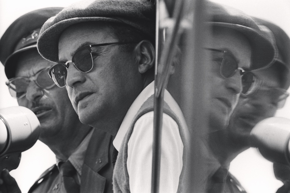 The Italian film producer Dino De Laurentiis watching the shooting of the film 'Tempest' alongside a Yugoslavian Army Colonel. Dolov, 1958 (Photo by Mario De Biasi/Mondadori Portfolio via Getty Images)