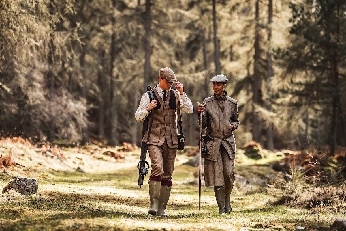 Left: Constable Burton tweed cap, birdseye tie, men’s Tattersall shirt, men’s tweed shooting vest, men’s tweed breeks with storm cuff, Caythorpe handknitted shooting sock, Swatcom ear defenders, bridle leather gun cover, bridle leather cartridge bag. Right: Litton short peak tweed cap, ladies’ beltback field coat, Staghorn thumbstick, ladies’ tweed culottes, Swatcom ear defenders.