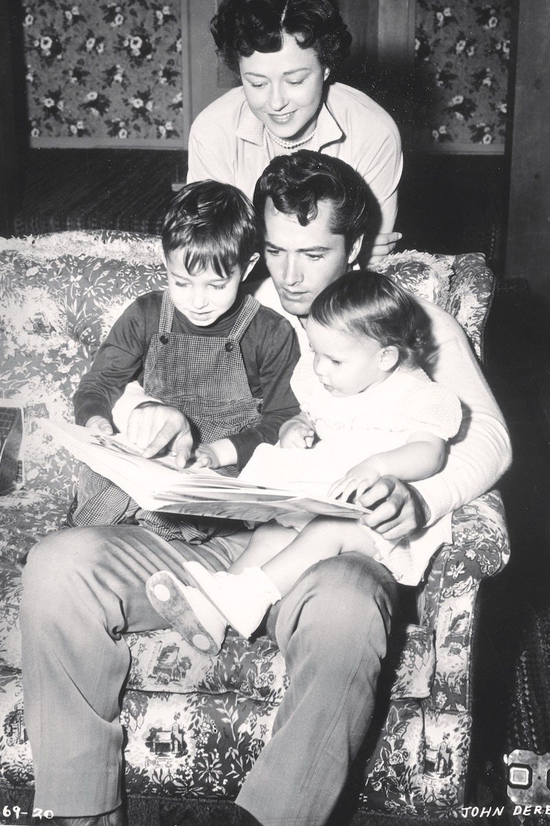 Reading with his son, Russell, and daughter, Sean Catherine, 1955. (Photo by Hulton Archive/Getty Images)