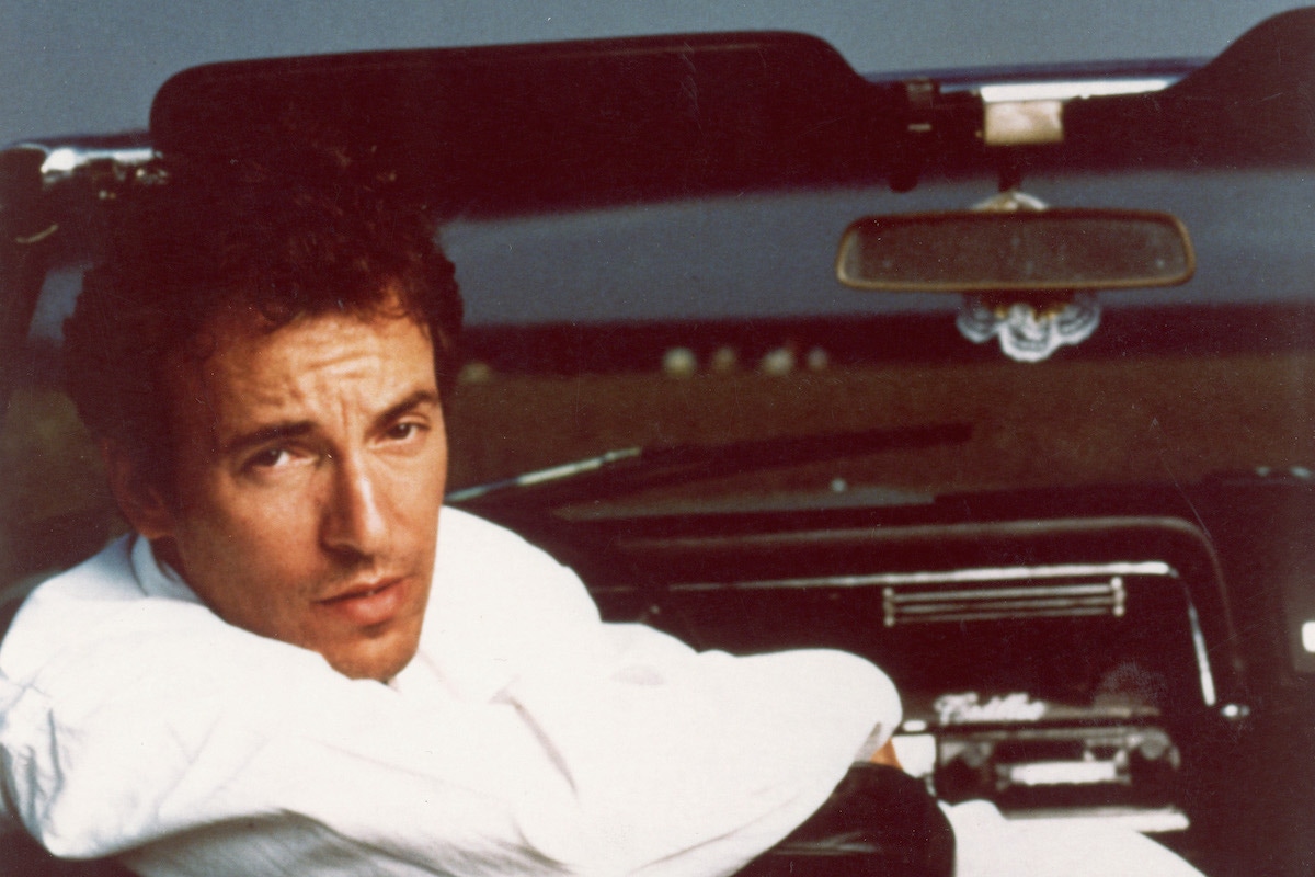 Portrait of American rock singer and songwriter Bruce Springsteen sitting in the driver's seat of a Cadillac convertible, circa 1987. (Photo by Hulton Archive/Getty Images)