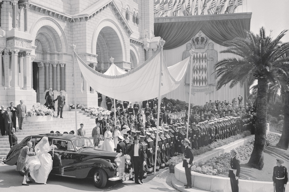 Grace Kelly arrives at the cathedral of St. Nicholas on her wedding day, with her father (at the front of the car) waiting to escort her, 1956. (Photo via Getty)