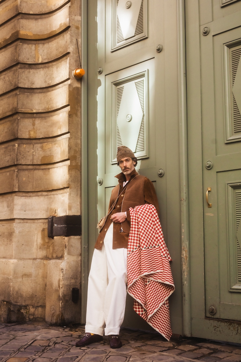 Richard wears: White cotton knitted long-sleeved Henley shirt, Anderson & Sheppard at The Rake; cognac suede driver overshirt, brown car vest, red and white check blanket, all Connolly; Fair Isle beanie hat, Anderson & Sheppard; trousers, shoes and wallet, stylists own.