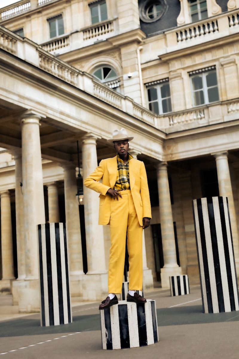 Kevis wears: Amalfi yellow Heritage jacket, Amalfi yellow Heritage contemporary trousers, both Edward Sexton; shirt, hat and shoes, models own.