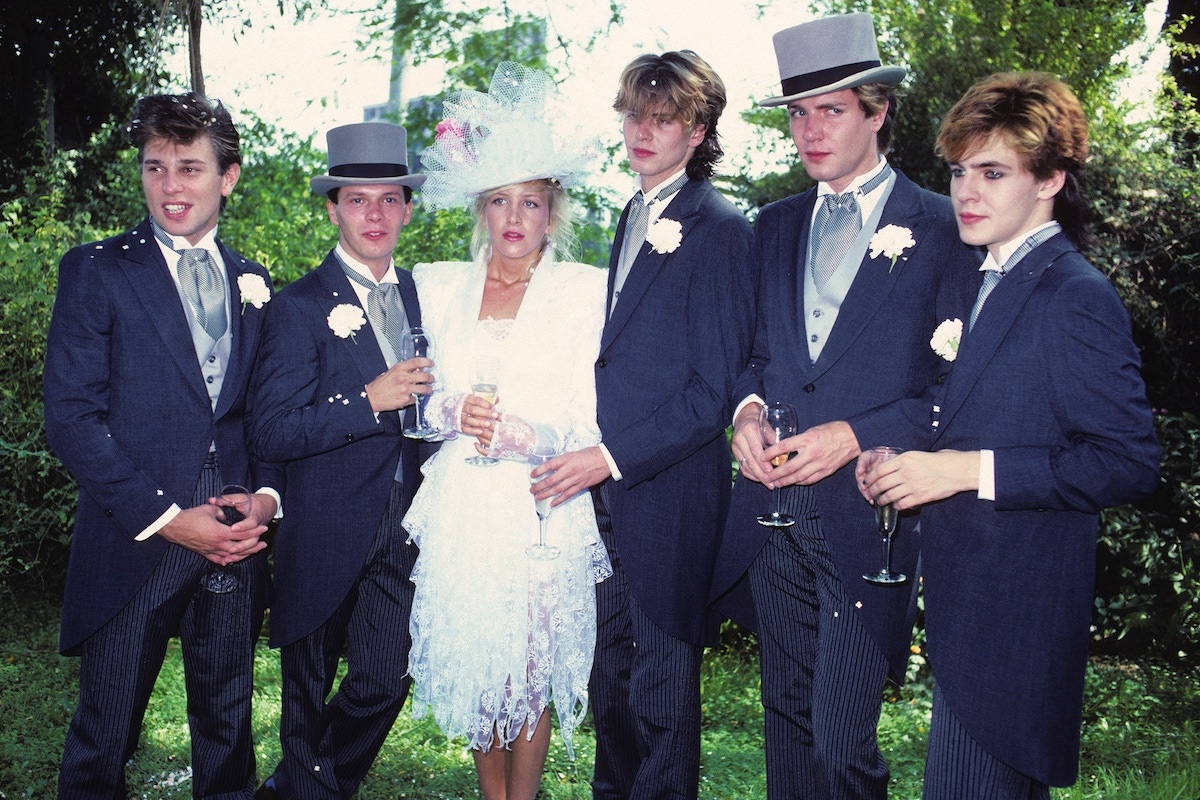 Andy Taylor, second from left, and his wife, Tracey, with members of Duran Duran during their wedding at Chateau Marmont in Los Angeles, 1982. (Photos by Brad Elterman/FilmMagic via Getty))