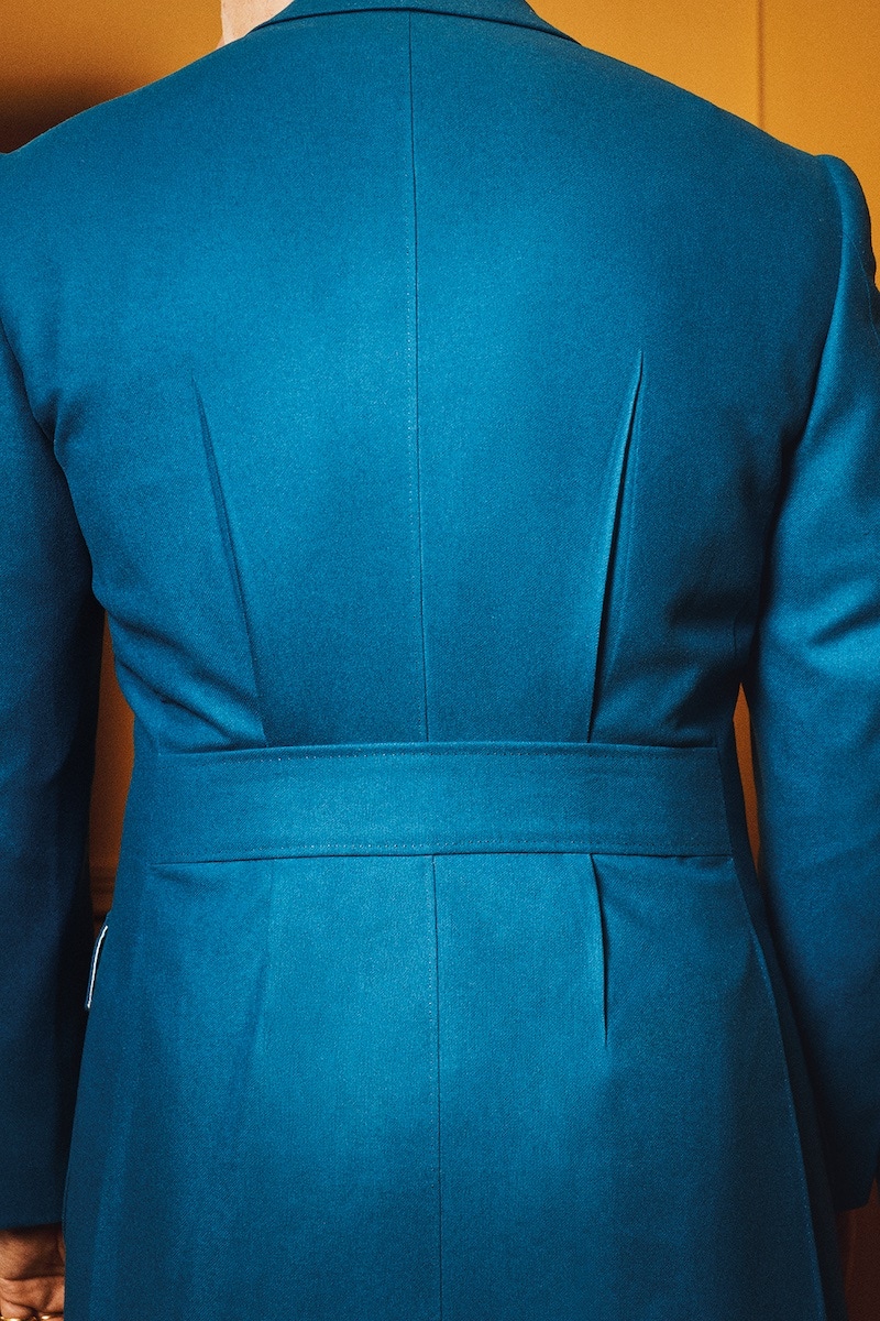 The half belt and pinch pleats in sharp relief.