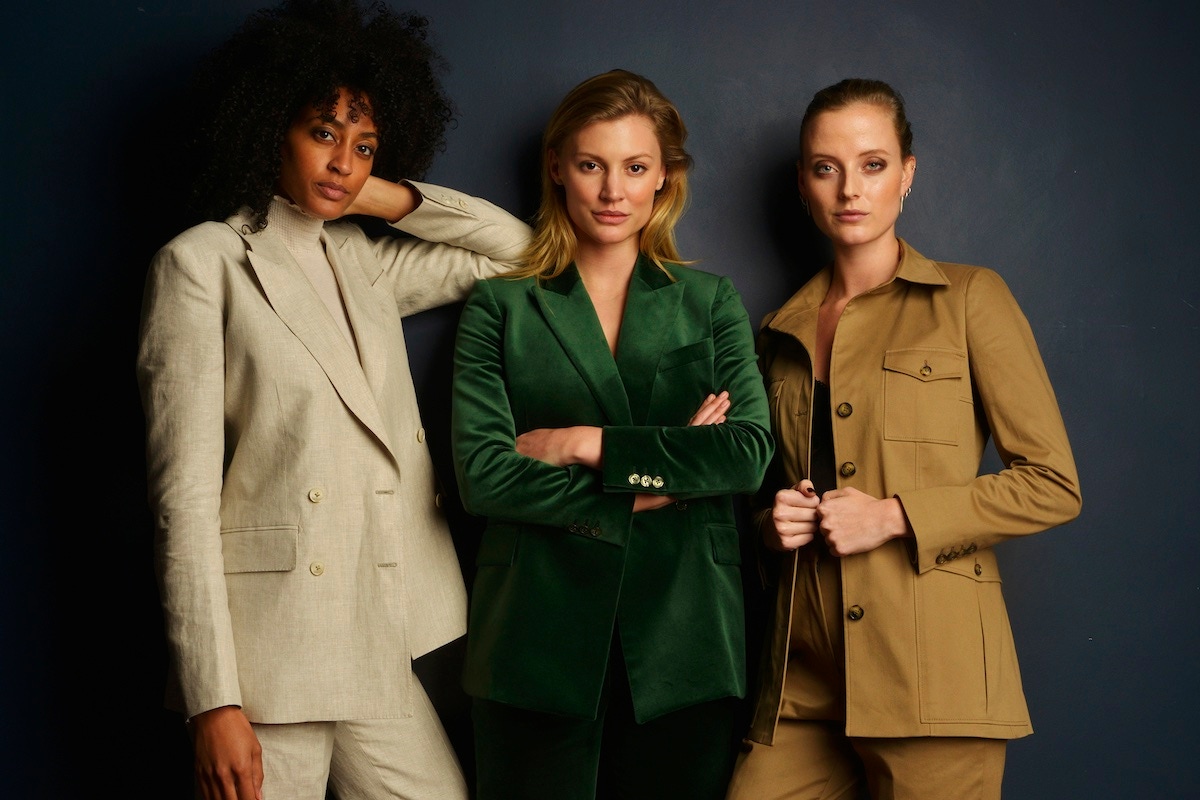 Keziah in an oatmeal linen boyfriend ‘Club’ suit; Amo Voelker wears a green velvet double-breasted ‘Spade’ suit, and Emily wears a camel cotton safari ‘Diamond’ suit