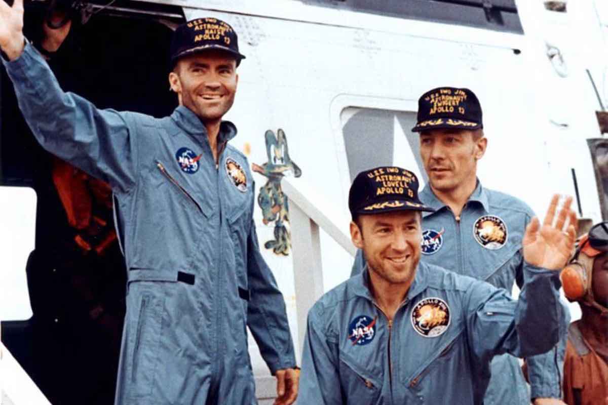 The Apollo 13 crew — Fred Haise (left), Jim Lovell (center), and Jack Swigert — step aboard the “USS Iwo Jima” following splashdown and recovery operations in the south Pacific Ocean on April 17, 1970 (Image: NASA.gov)]