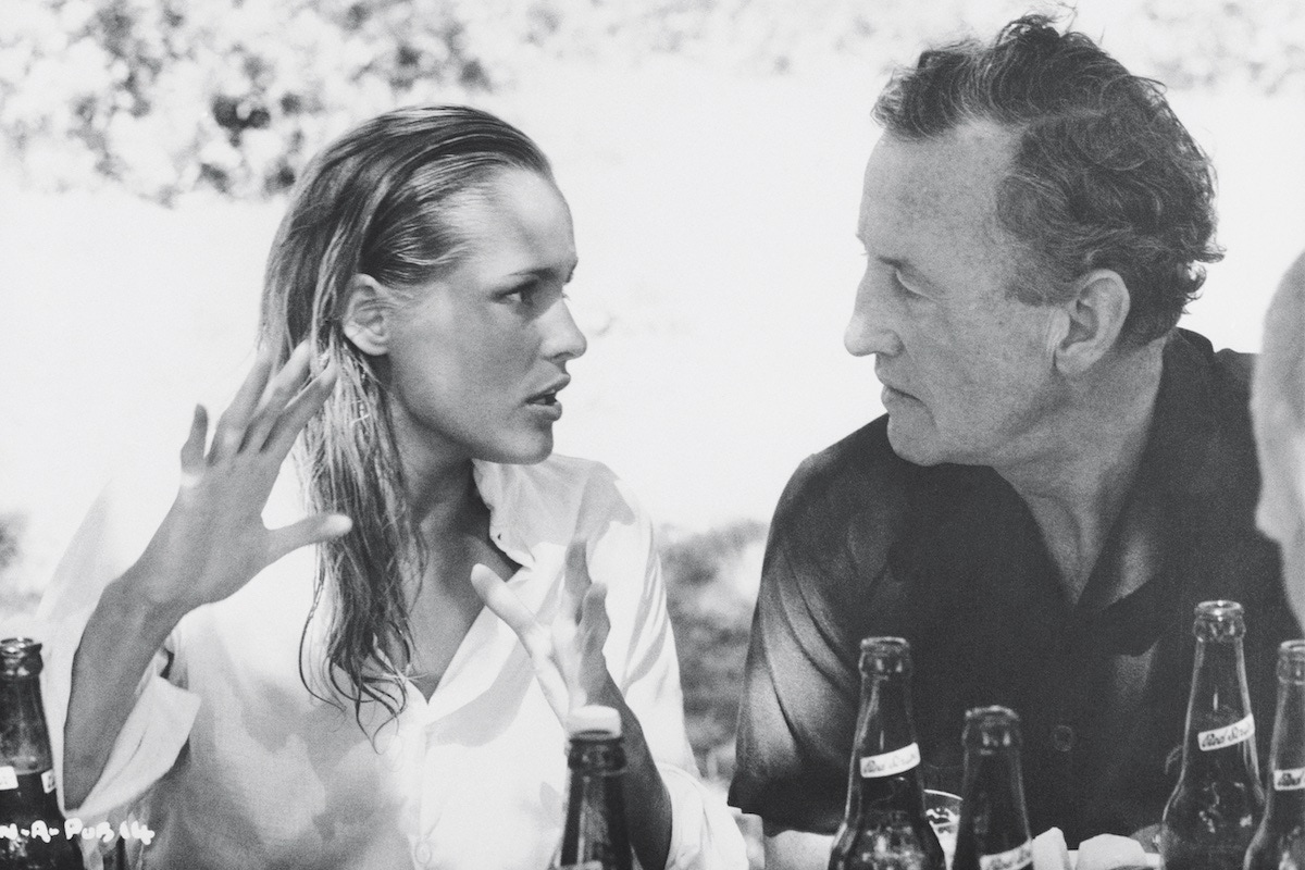Fleming chats to Ursula Andress during the filming of Dr. No. (Photo via Getty)